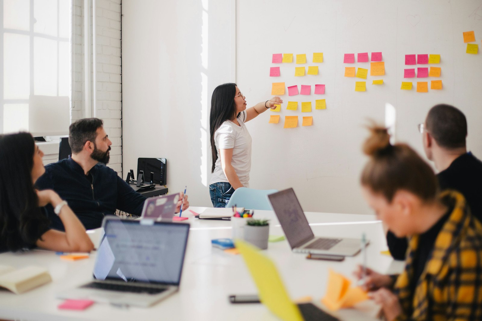 Editorial team reviewing data and websites around a meeting table
